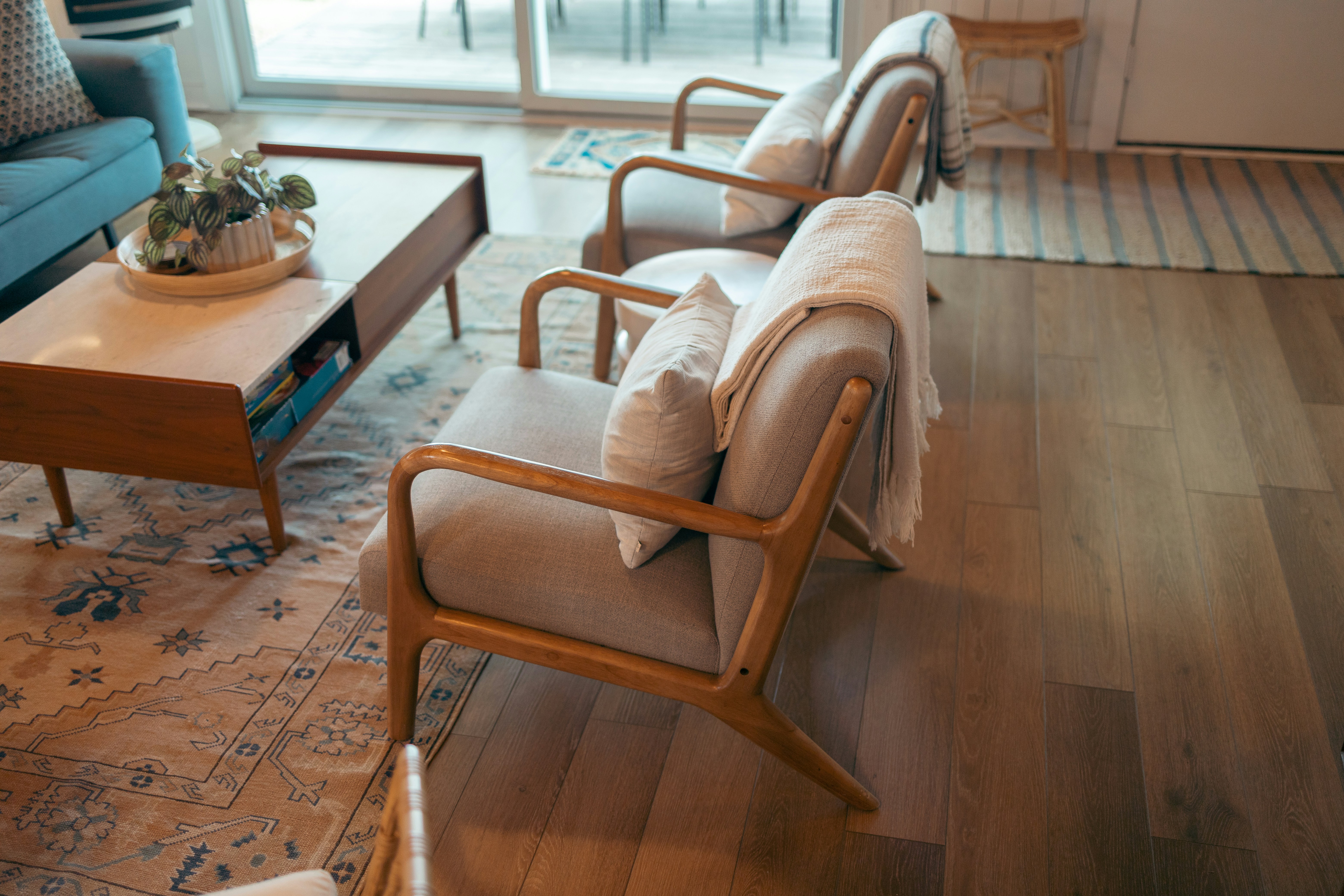 Airbnb interior — mid-century chairs, warm timber, natural light